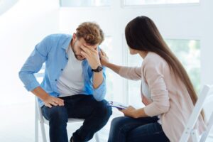 Nice sympathetic therapist consoling her patient